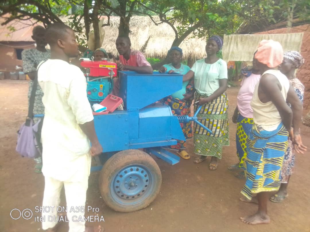 The Kouti villagers surrounded by the oil extraction machine.