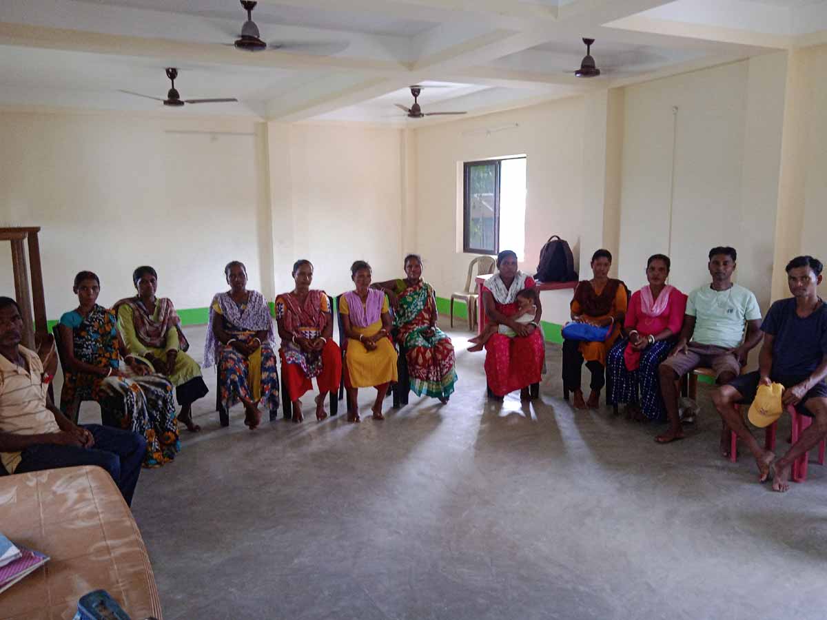 The Tea Garden Cluster of India having a meeting indoors about Education and its impact in the village.