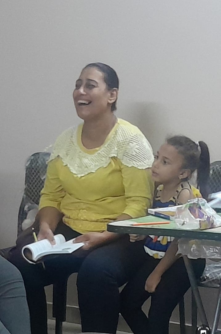 Egyptian mother, Nader, laughing as she shares her story.