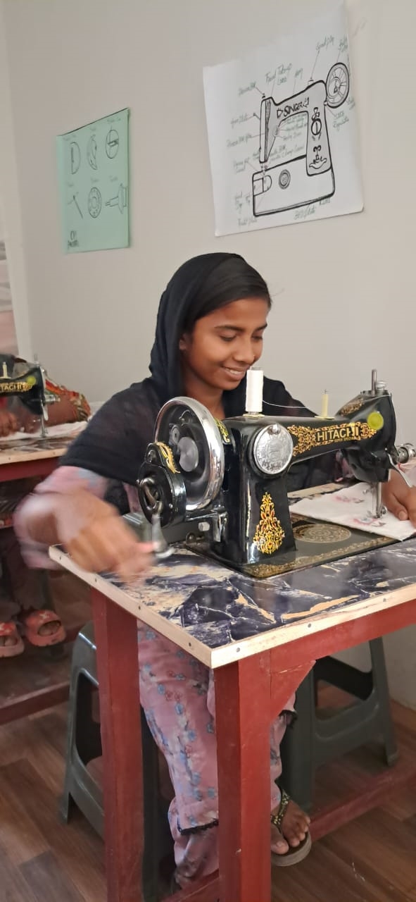 Sindh Province villager, Risshani, enjoying her sewing learning.