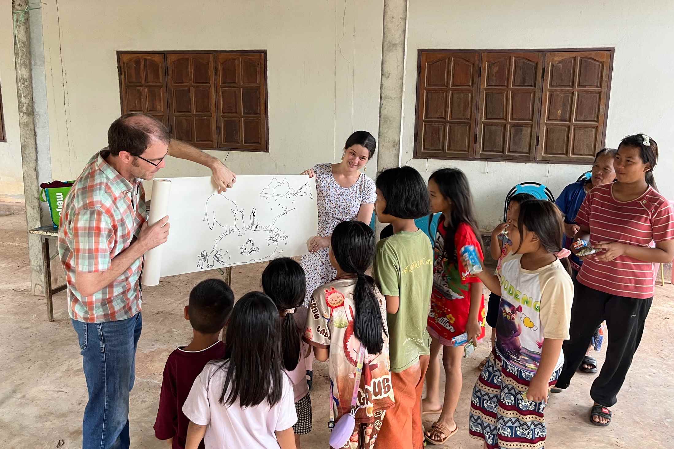 TCD teachers teaching Thailand children about clean water at Ratchaboot Village.