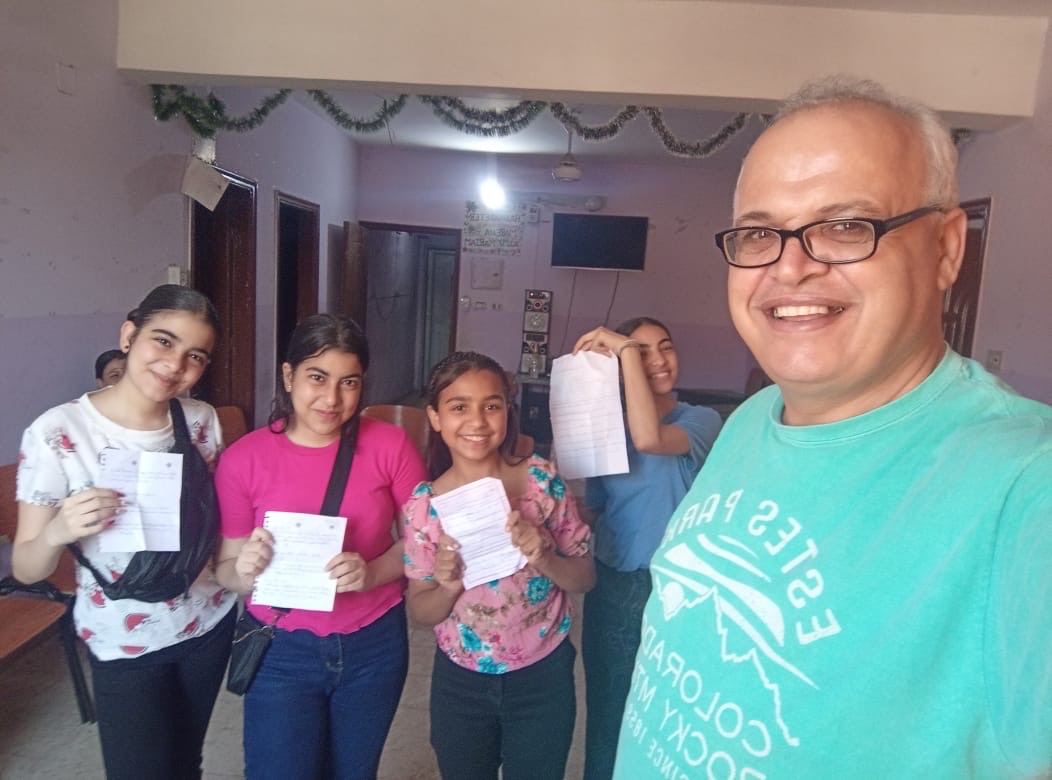 A TCD teacher with his students at Ezbit el Nakhl Village.