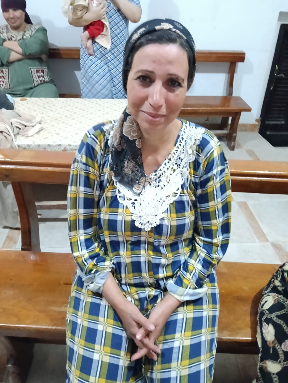 Mrs. Umm Ashraf sitting for a causal profile photo.