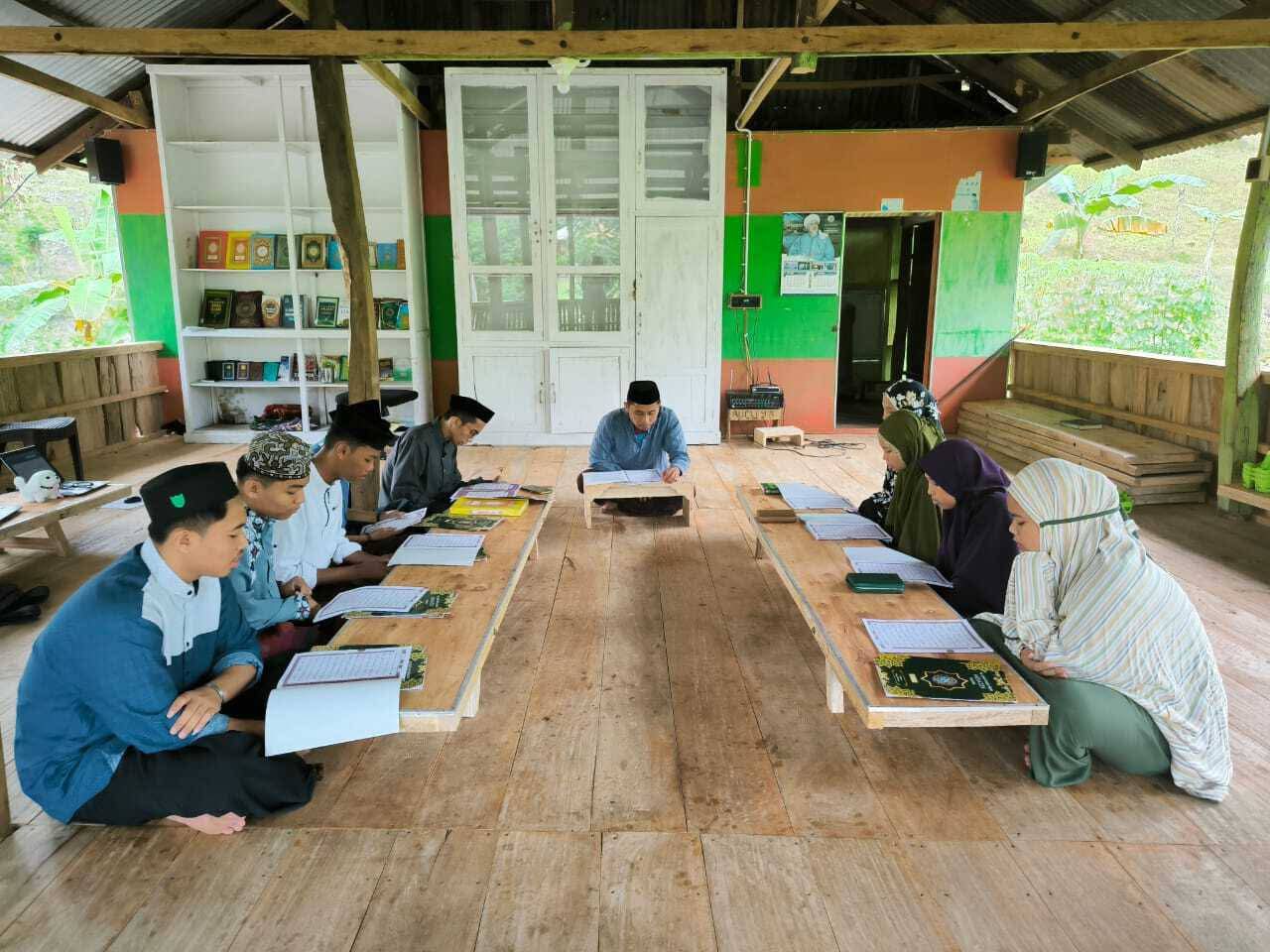Community member, Irwan, leading a study indoors in Polewali, Indonesia.
