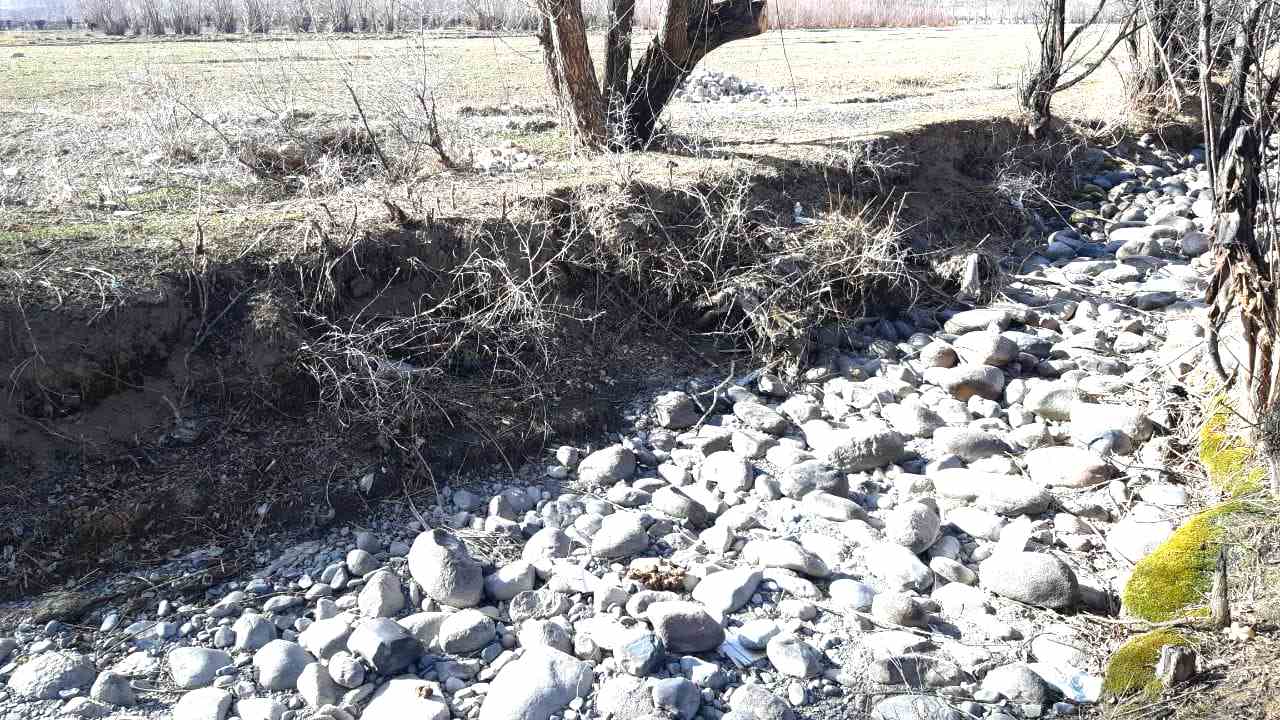 A stretch of land dug up for a current of water to flow at a Kyrgyzstan village.