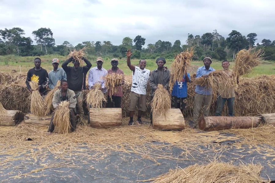Effaoho villagers showing their large harvest of rice.