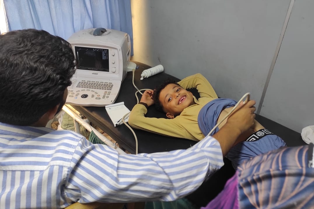 A doctor running a test on an Al Dawadia child.
