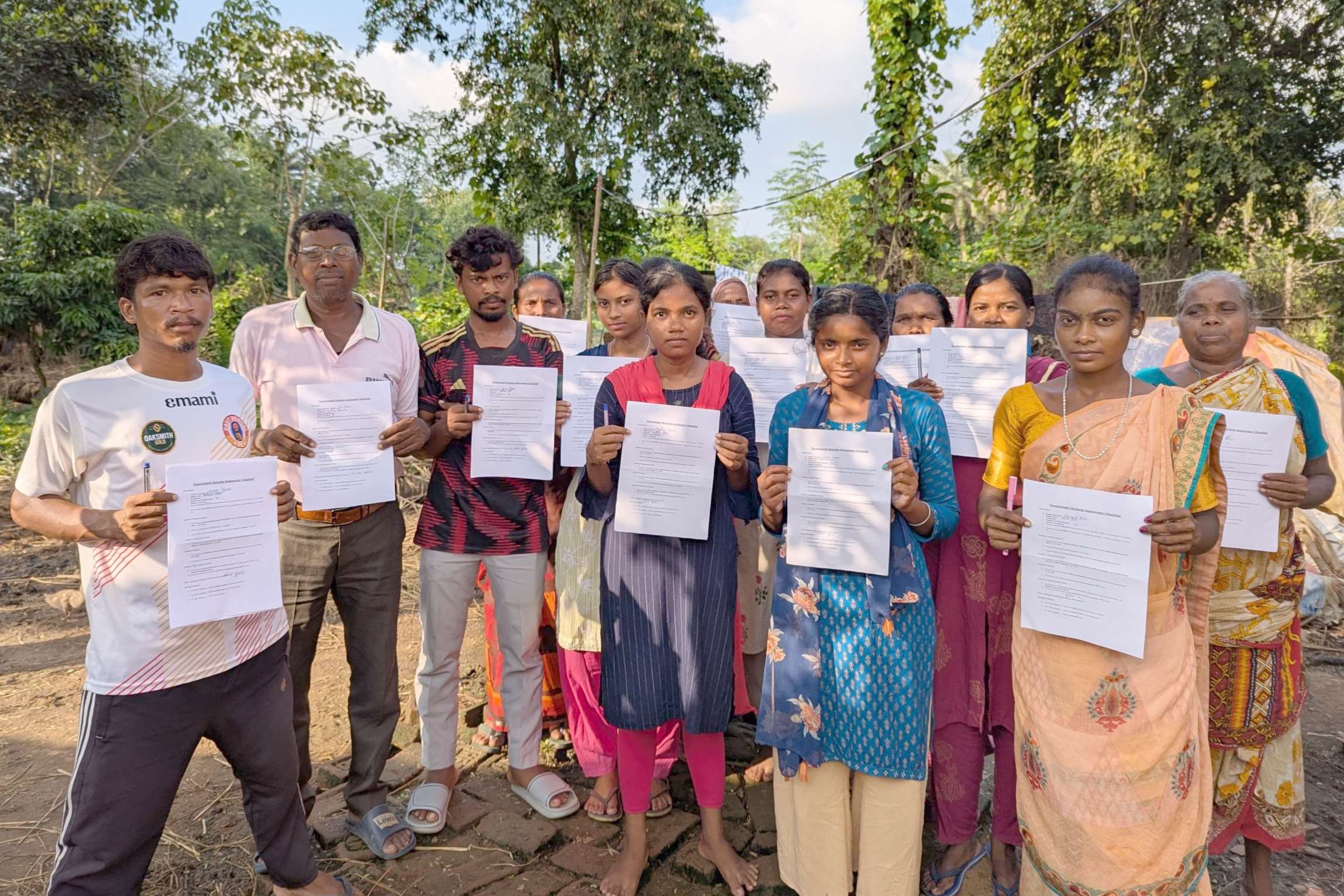 Some of the Shri Ambra community each holding a piece of documentation on the future of their village.