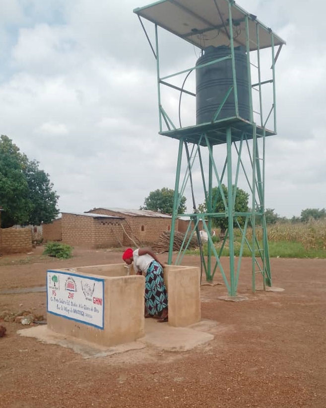 A Mali villager using a water pump.