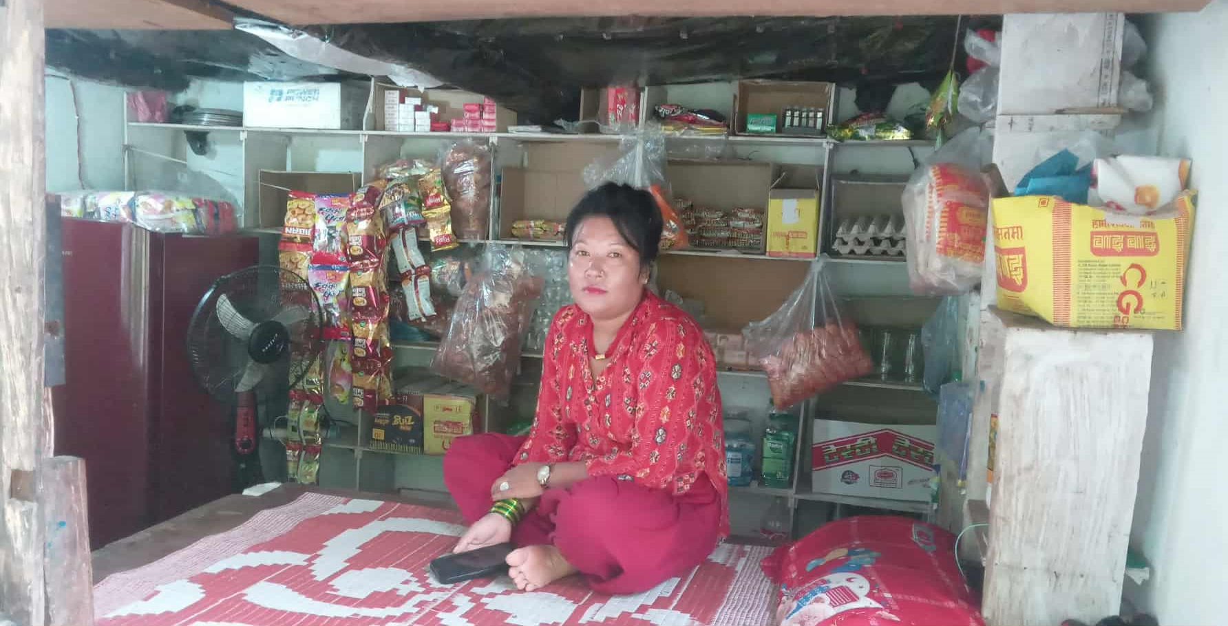 A Ramantar female villager with her food stand.