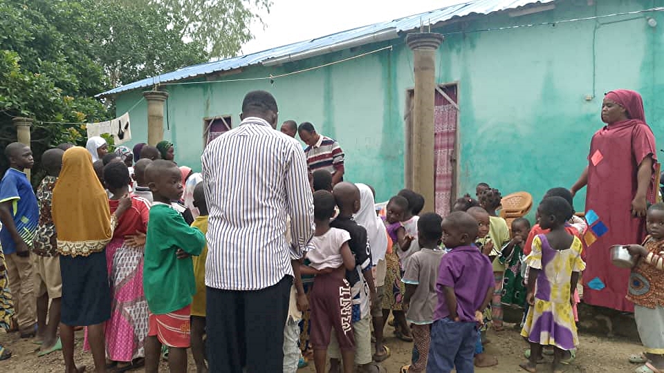 A group of children gather as they acquire their new school supplies.