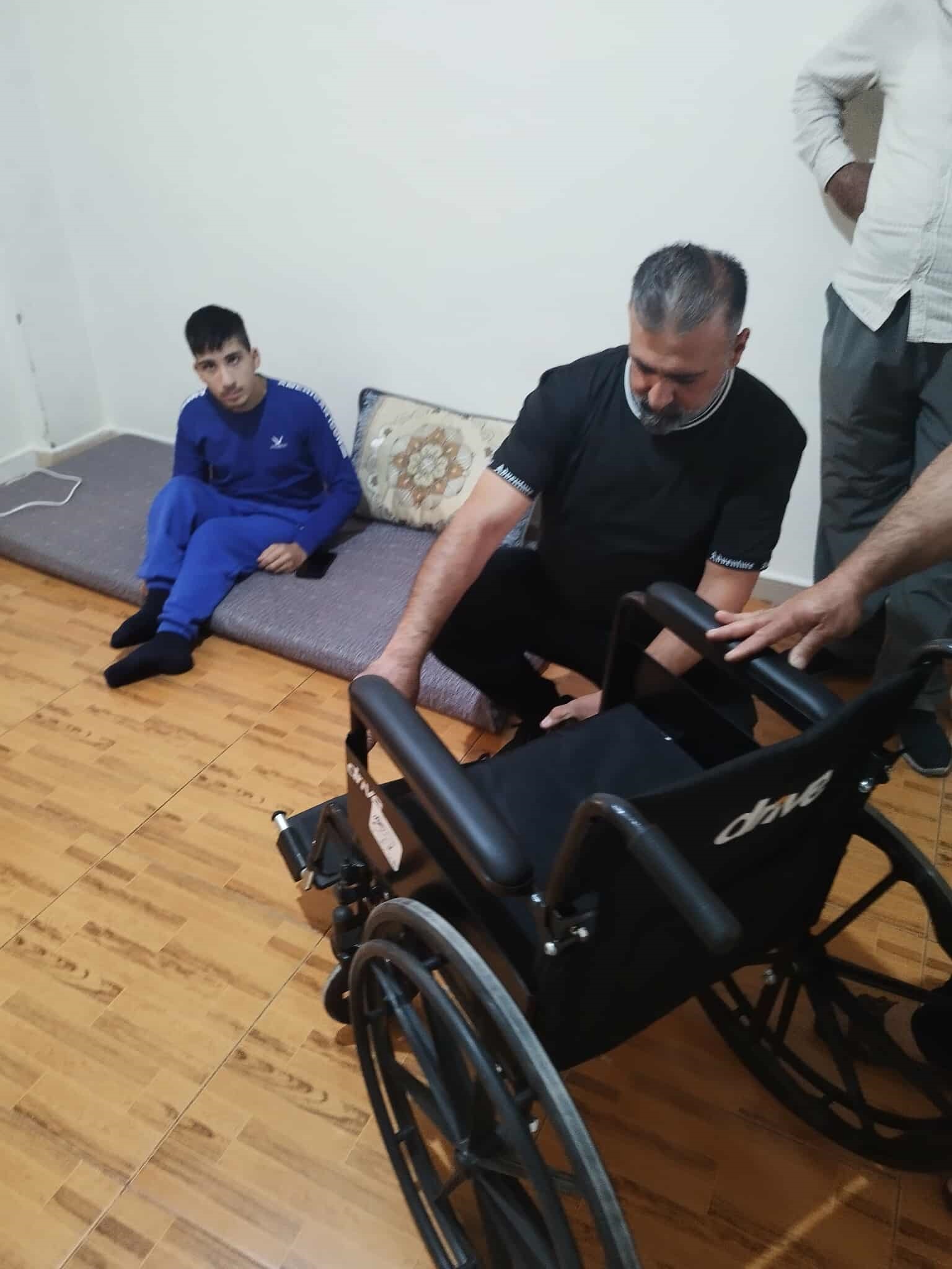 TCD members setting up a wheelchair for a House of Ruth resident.