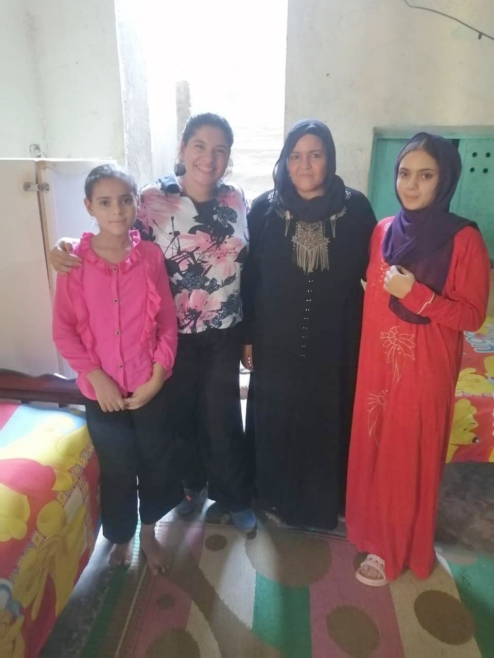 A group photo of three Nubian female villagers and their TCD teacher.
