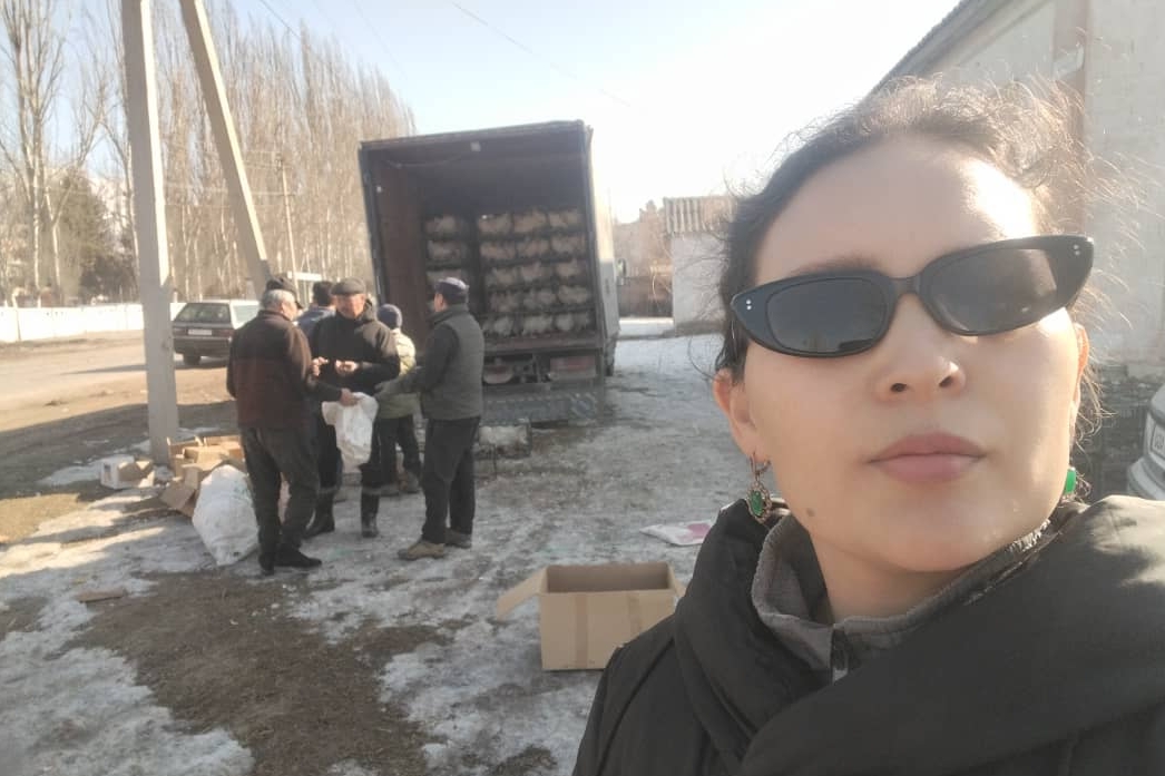 A selfie photo as some goods are being dropped off by a truck.