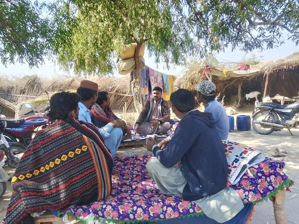 A small group of Pakistan villagers as they are focused on the listener.