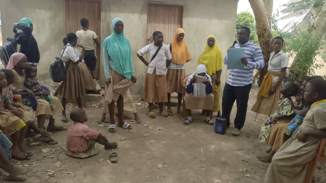 A TCD lesson being conducted in a circle at Birini VIllage.