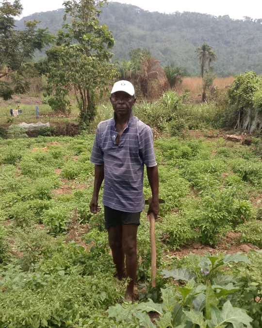 Komende villager, Pa John, out on the field.